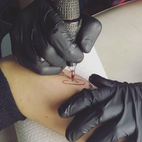 carpe diem being tattooed